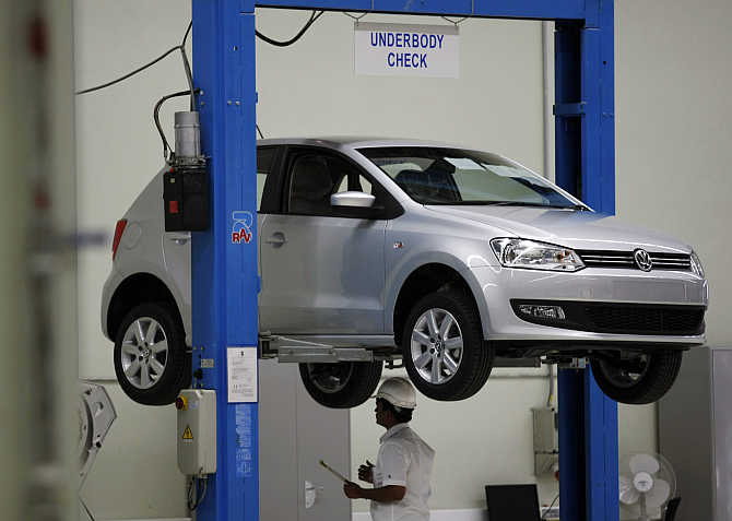 An employee inspects Polo at the assembly line at the Volkswagen's plant in Chakan, about 180km south of Mumbai.