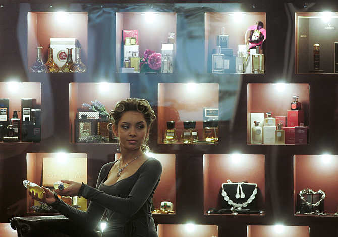 A woman presents perfume at the Millionaire Fair in Moscow, Russia.
