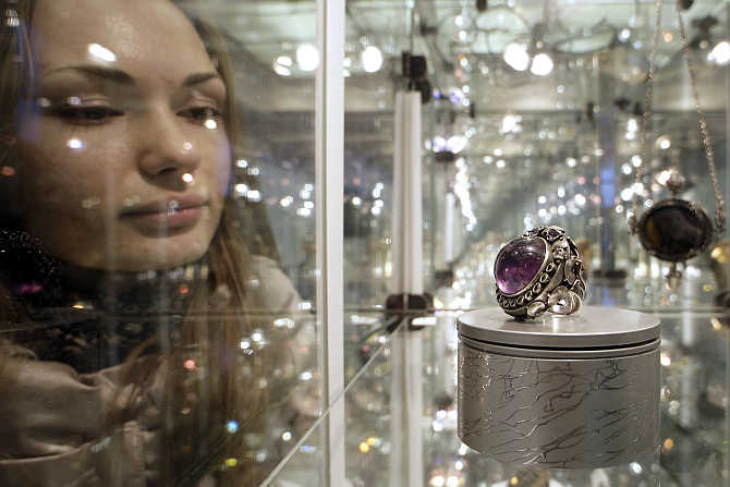A visitor looks at an item on display at the annual St Petersburg's Jeweller International Exhibition in Russia.