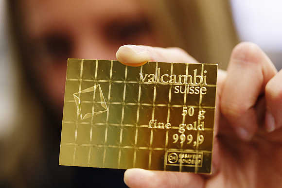 An employee shows a gold Combibar in Balerna, Switzerland.
