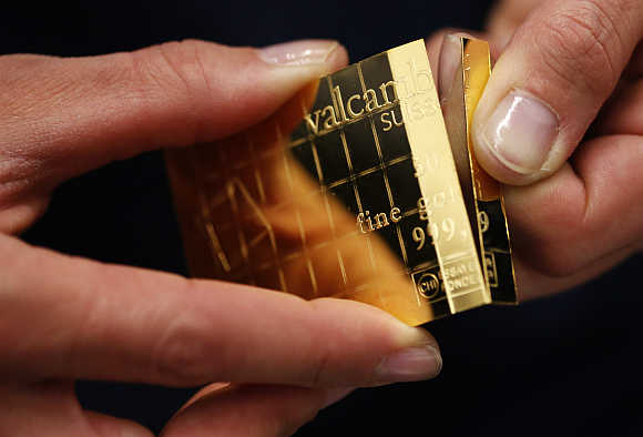 An employee divides a gold Combibar in Balerna, Switzerland.