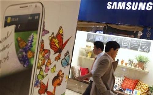 People walk at a Samsung Electronics store.