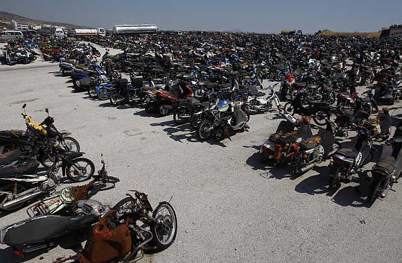 Damaged and confiscated motorcycles in a yard of Oddy in Athens.