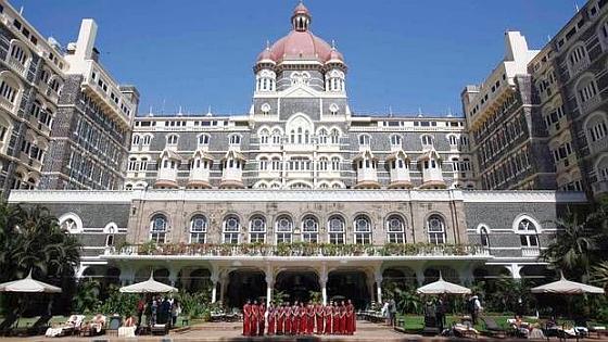 Staff of the Taj Mahal Palace hotel pose in Mumbai.