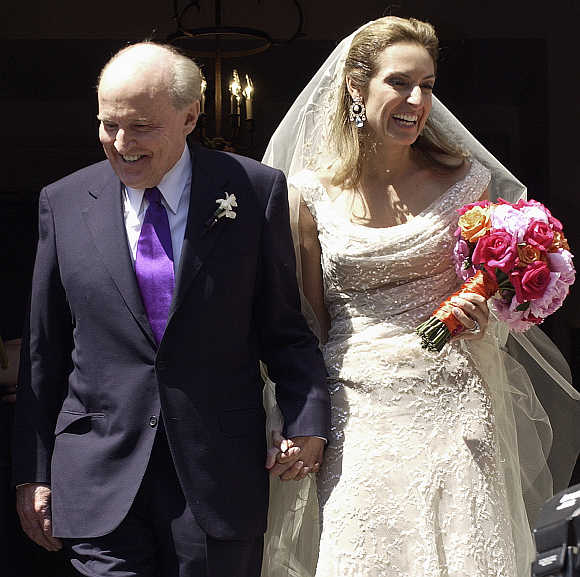 Former CEO of General Electric Jack Welch walks down the steps of Park Street Church with Suzy Wetlaufer after their wedding in Boston, Massachusetts.