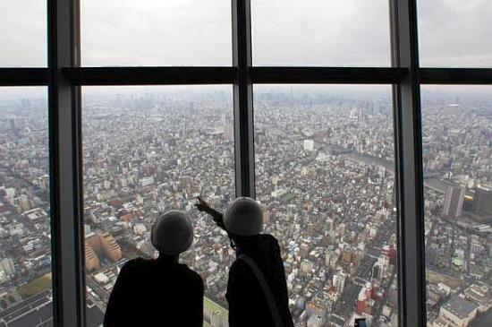 Reporters observe a panoramic view of the city of Tokyo.