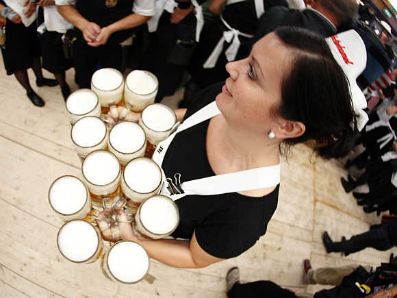 A waitress serves beers during the opening ceremony of the Oktoberfest in Munich, Germany.