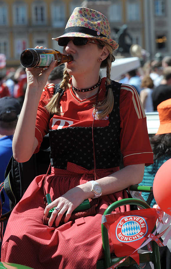 A Bayern Munich supporter drinks beer in downtown Munich Germany.