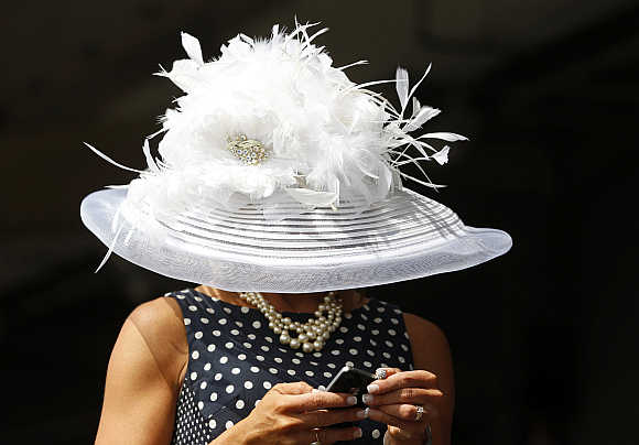 A race fan checks her phone before the 138th running of the Kentucky Derby at Churchill Downs in Louisville, Kentucky, United States.