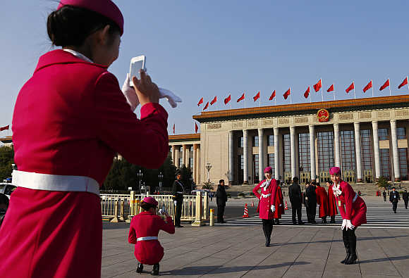 Hotel guides in front of the Great Hall of the People in Beijing, China.