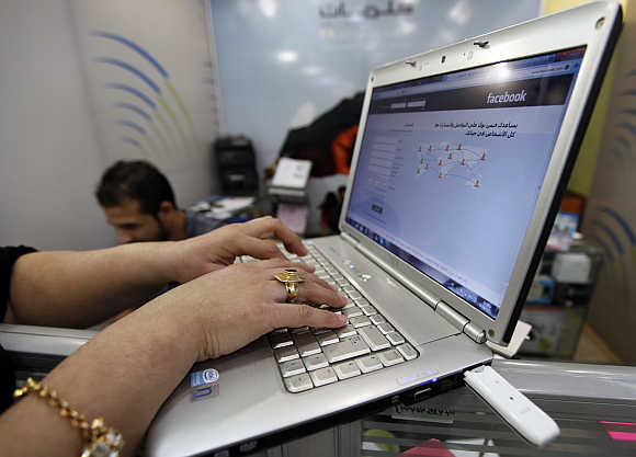 A woman uses wireless Internet at a shop in Baghdad, Iraq.