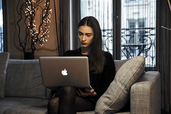 French model Marine Deleeuw reads her emails in Paris.