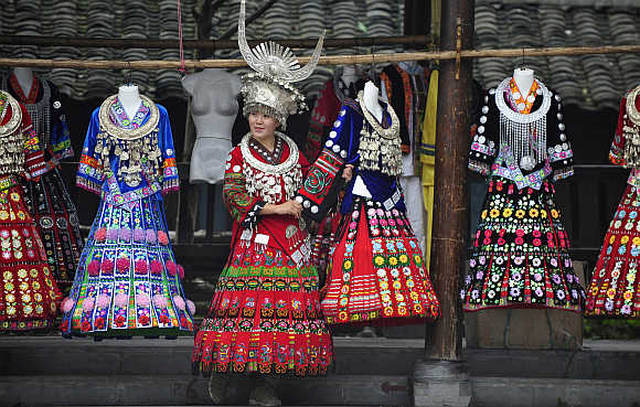A visitor tries on a Miao ethnic gown in Leishan county, southeast Guizhou province.
