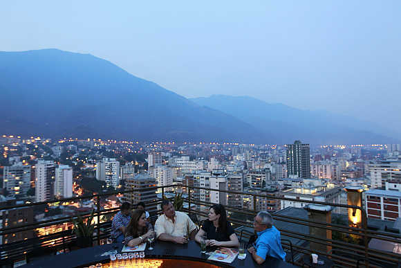 People have a drink at 360, a three-tiered rooftop bar, in Caracas.