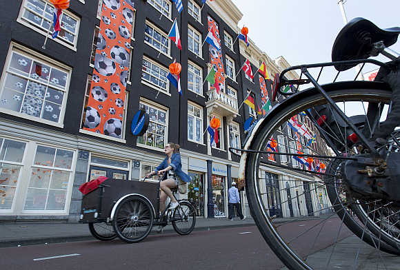 A woman rides her bicycle in Amsterdam.