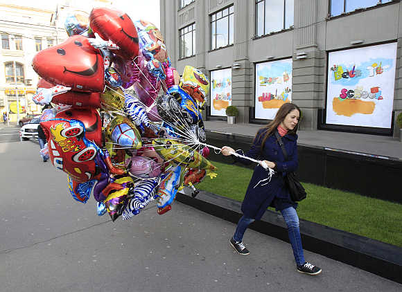 A woman carries balloons in central Moscow.