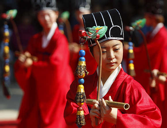 A university student wears traditional costume while peforming during the grand Confucian ceremony at Sungkyunkwan University in Seoul.