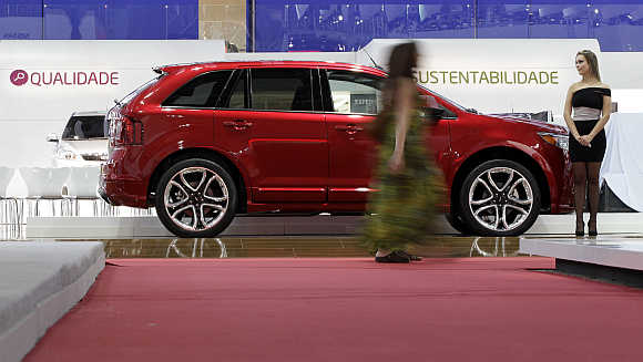 A model walks past a Ford Edge in Sao Paulo, Brazil. Photo is for representation purpose only.