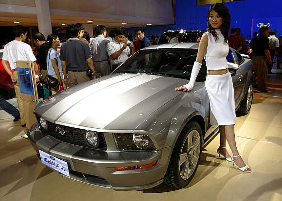A Chinese model poses with a Ford Mustang GT in Beijing. Photo is for representation purpose only.