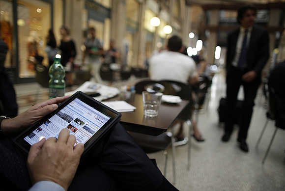 A man uses his iPad tablet in Rome, Italy.