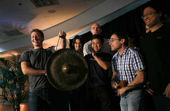 Mark Zuckerberg holds a gong at Facebook headquarters in Palo Alto, California