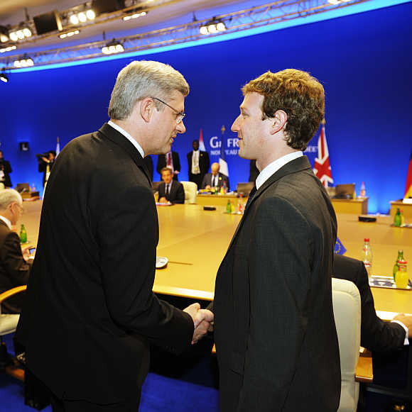 Mark Zuckerberg shakes hands with Canada's Prime Minister Stephen Harper in Deauville, France.