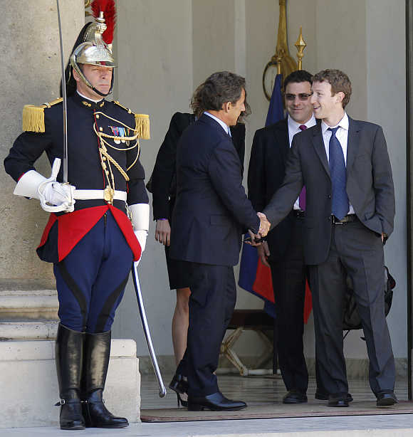 France's then-president Nicolas Sarkozy shakes hands with Mark Zuckerberg at the Elysee Palace in Paris.