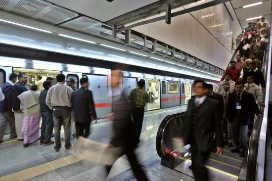 Commuters arrive to an underground metro train station.