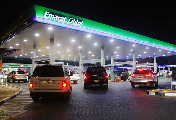 Vehicles queue for petrol at an Emarat gas station in Dubai.