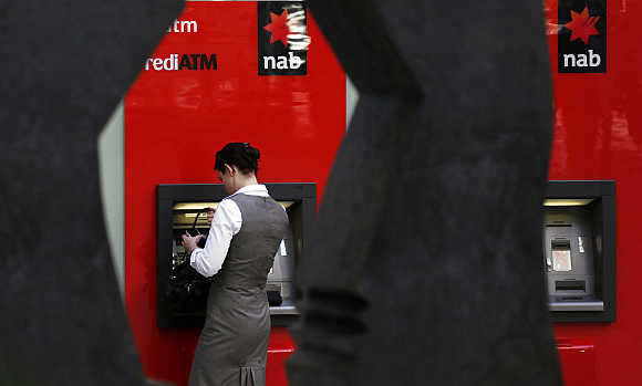 A woman uses a National Australia Bank ATM in central Sydney.
