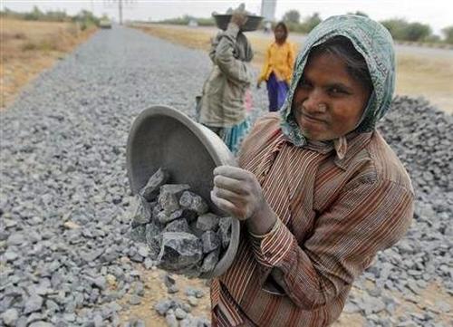 A labourer works at a road construction site in Ahmedabad.