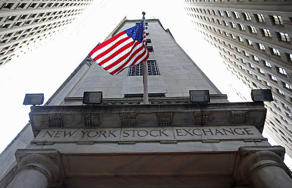 A flag flutters in the wind outside the New York Stock Exchange.
