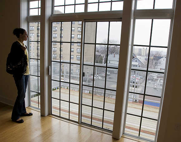 Prospective home buyer Jessica Doctoroff looks out the windows of a condominium for sale in Somerville, Massachusetts.
