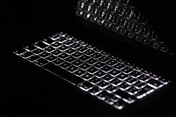 Backlit keyboard is reflected in screen of Apple Macbook Pro notebook computer in Warsaw, Poland.