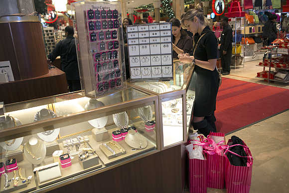 Shoppers look over items on sale at a Macy's store in New York City.