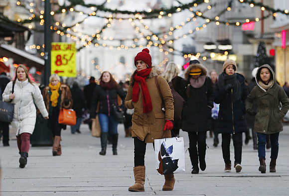 Shoppers walk along Karl Johans Gate, the main shopping street in Oslo.