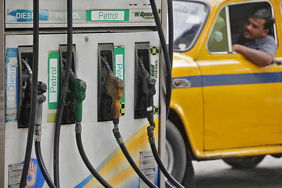 A driver waits to fill up his tank with diesel at a petrol station in Kolkata.