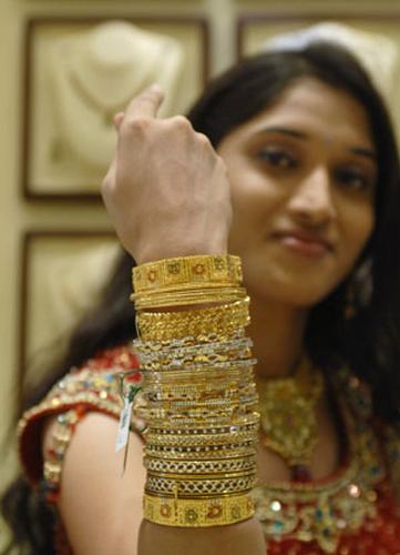 Model displays gold jewelry ahead of the Hindu festival of Akshaya Tritiya.