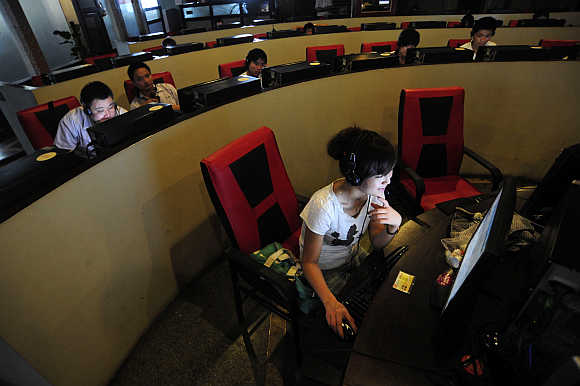 People use computers at an Internet cafe in Hefei, Anhui province, China.