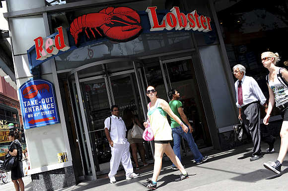 Passersby walk in front of the Times Square Red Lobster restaurant in New York.