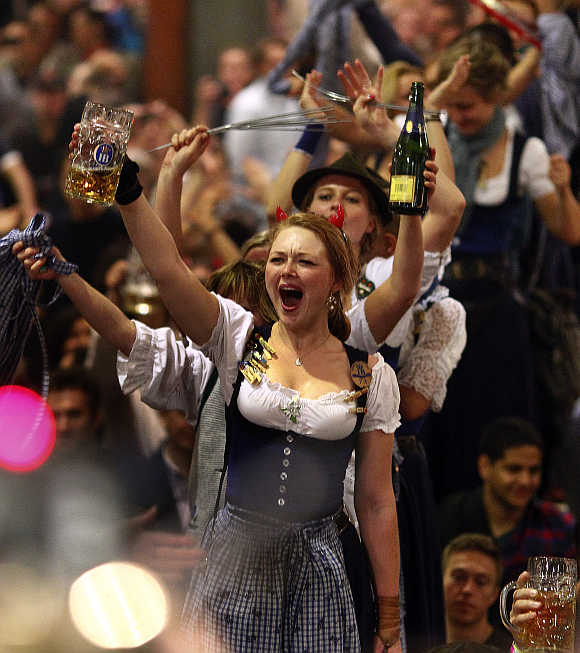 Waitresses dance on the tables during the beer festival, Oktoberfest, in Munich, Germany.