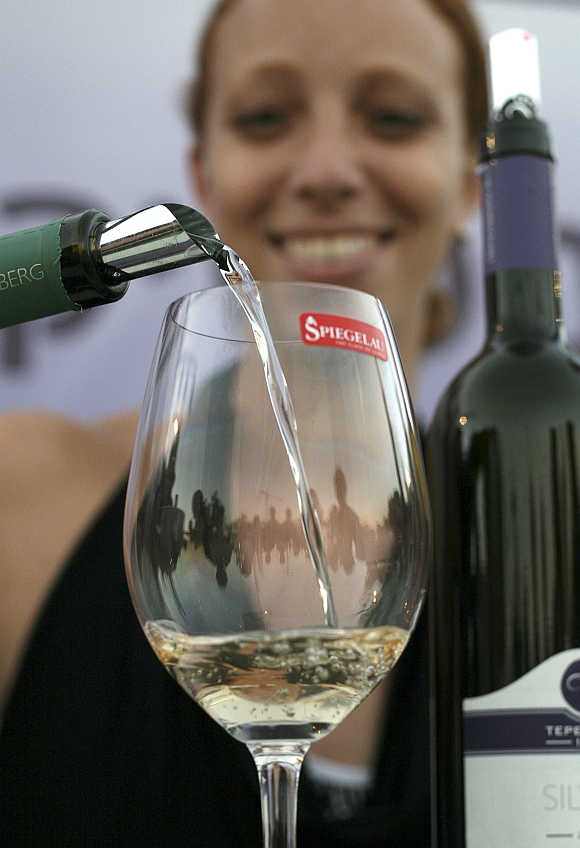 White wine is poured into a glass in Jerusalem.