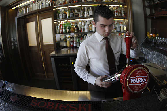 A bartender pours beer at the Sielanka nad Pilica Hotel in Warka, Poland.