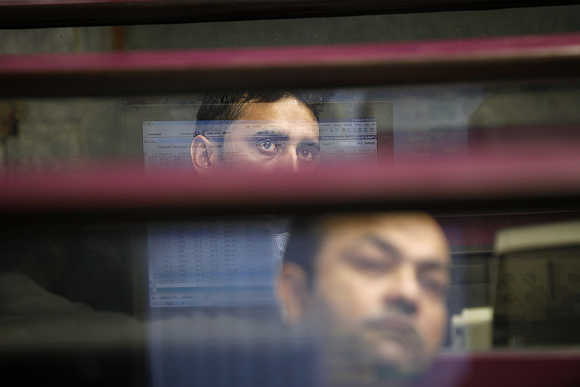Brokers monitor the market at the Karachi Stock Exchange.