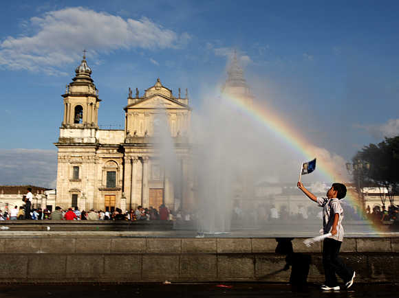 A child plays near a fountain at the Parque Central in Guatemala City.