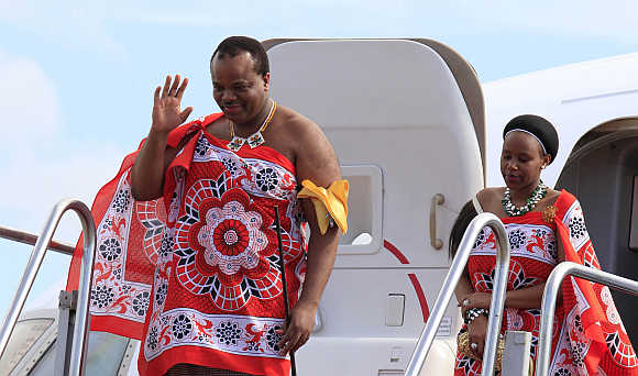 King of Swaziland Mswati III and his wife disembark a plane after arriving at Katunayake International airport in Colombo, Sri Lanka.