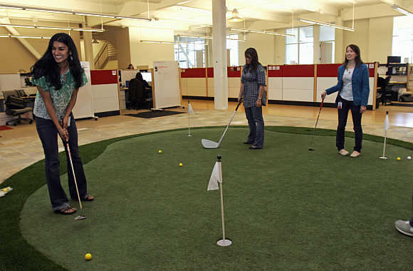 Employees play on the putting green at the YouTube headquarters in San Bruno, California.