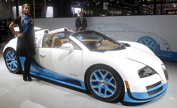 A model stands next to the Bugatti Veyron Grand Sport Vitesse in Doha, Qatar.