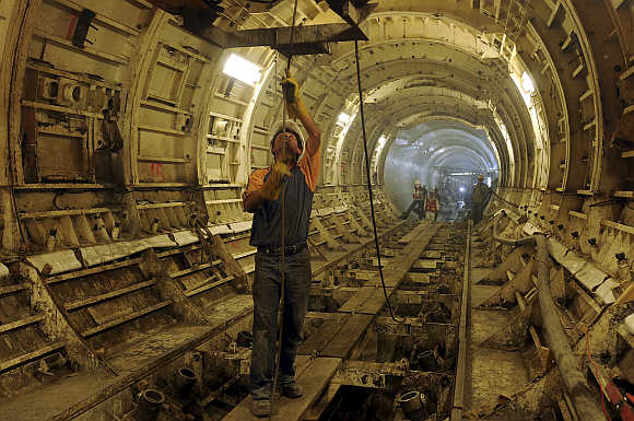 Workers carry out works in the underground deep drainage tunnel system in Mexico City.