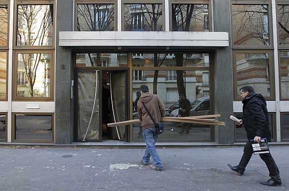 Construction workers enter a building in Paris.